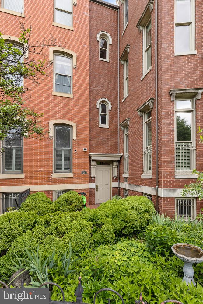 20 Logan Circle Northwest, Unit 32 Washington, DC 20005 - Photo 22 of 23 a brick building with a garden in front of it