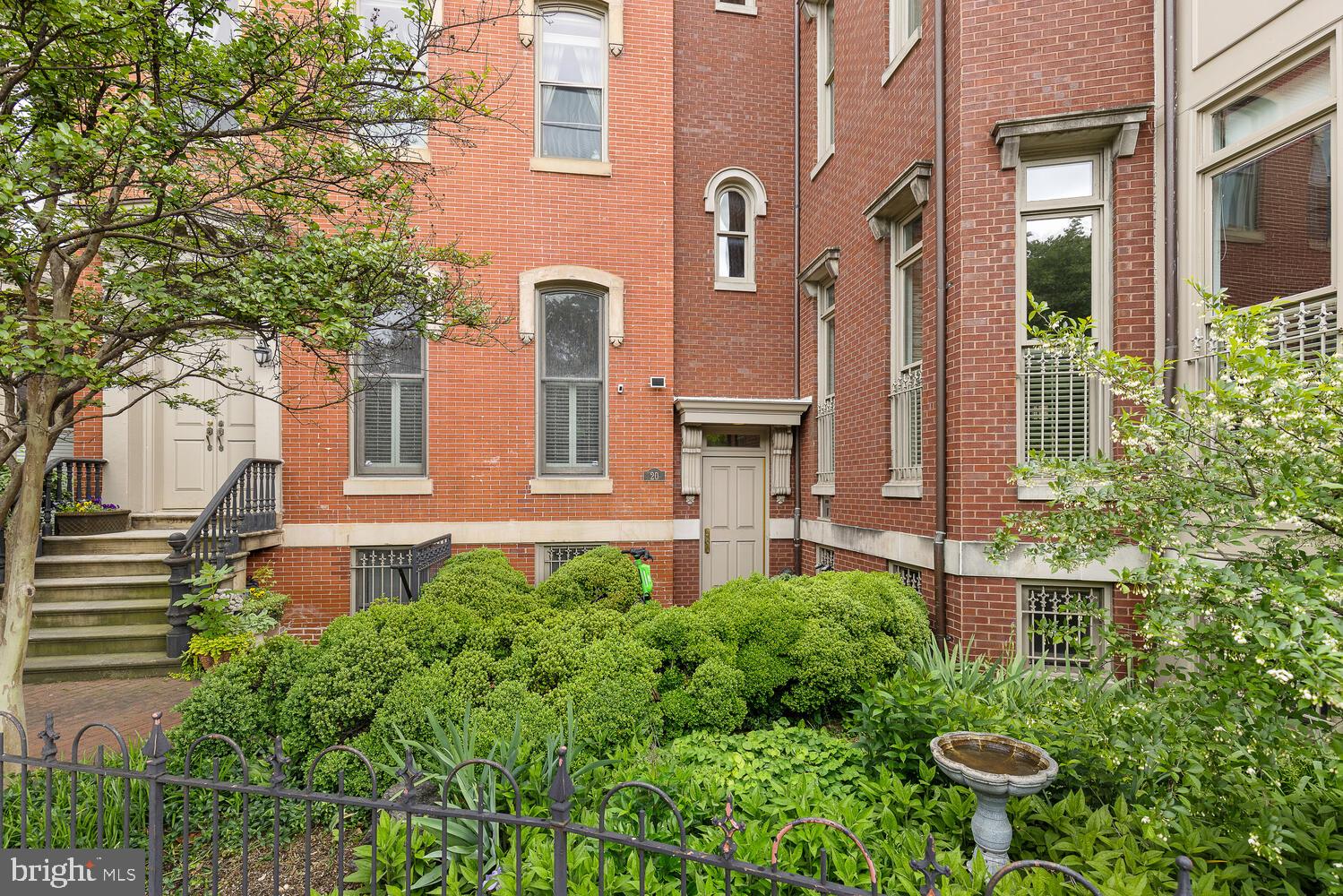 20 Logan Circle Northwest, Unit 32 Washington, DC 20005 - Photo 6 of 23 a view of a house with brick walls plants and large tree