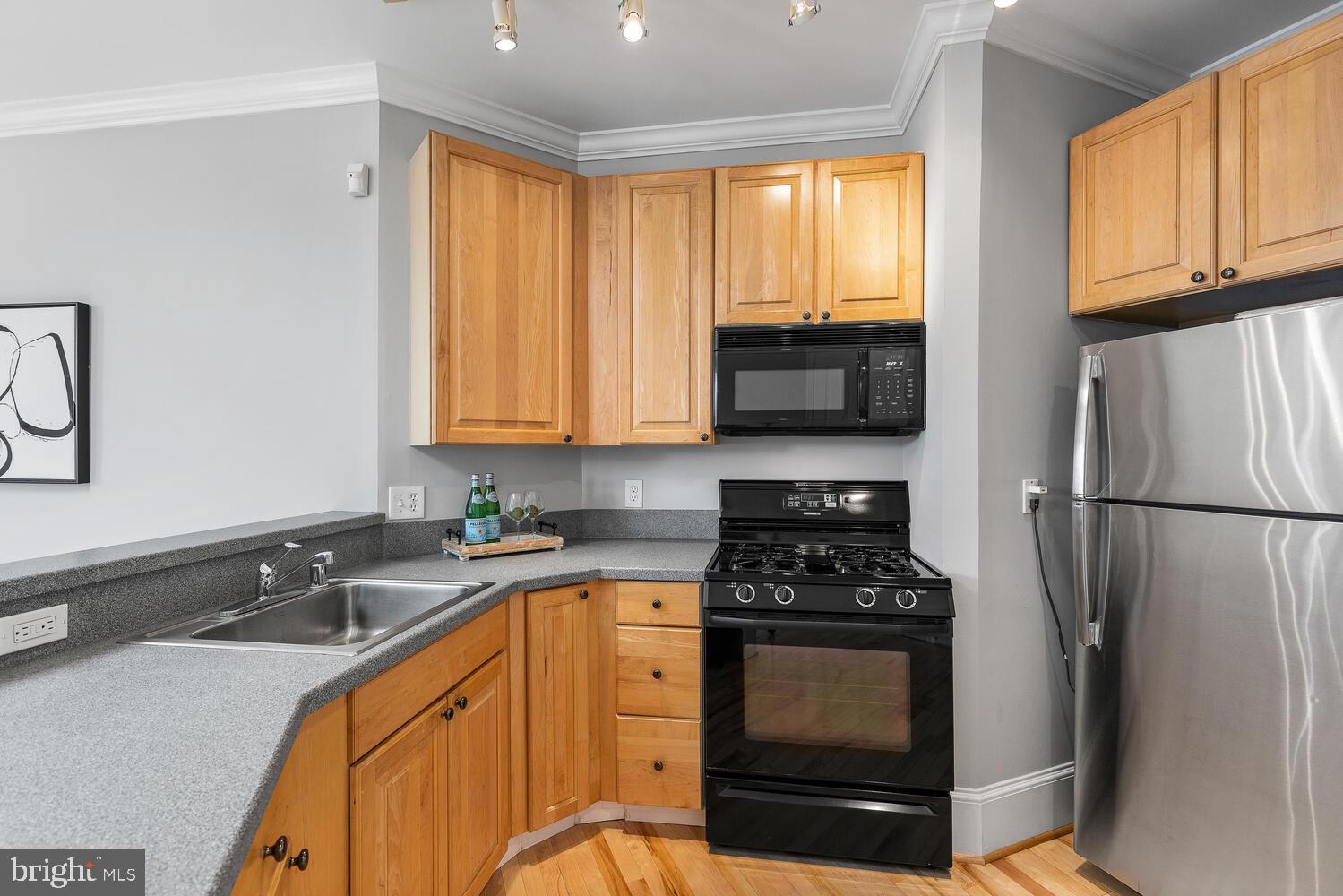 20 Logan Circle Northwest, Unit 32 Washington, DC 20005 - Photo 9 of 23 a kitchen with stainless steel appliances a stove a sink a microwave and cabinets