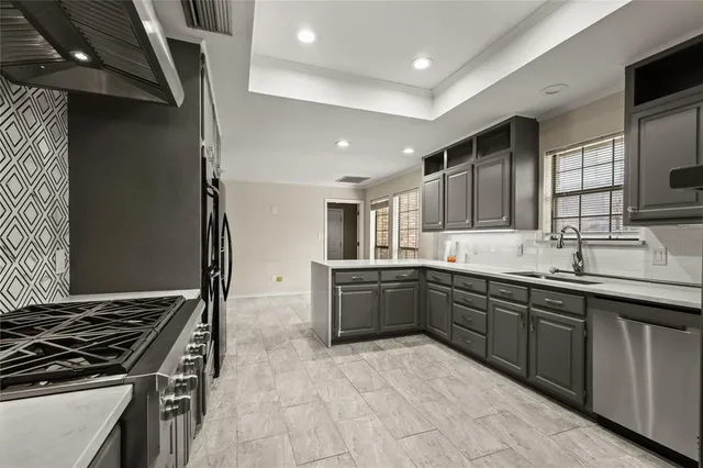 a view of an empty room with wooden floor and a large window