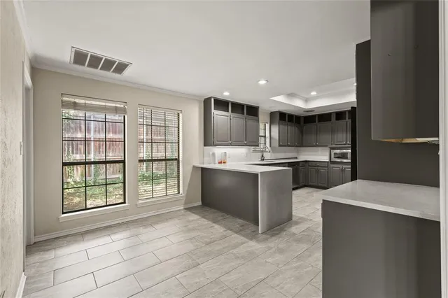 a living room with stainless steel appliances furniture and a large window