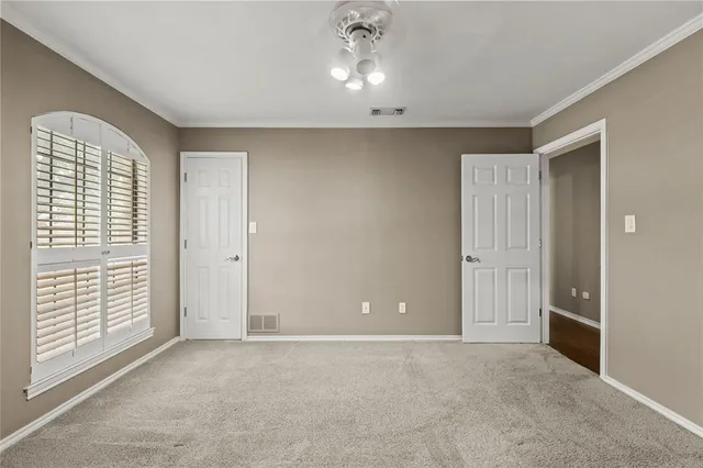 a large kitchen with a large counter top stainless steel appliances and cabinets