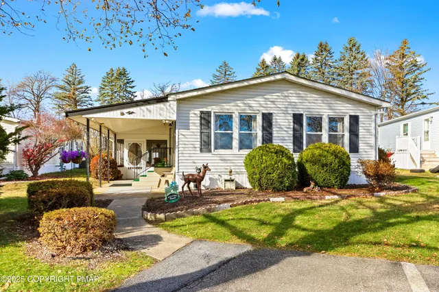 a view of a house with backyard porch and sitting area