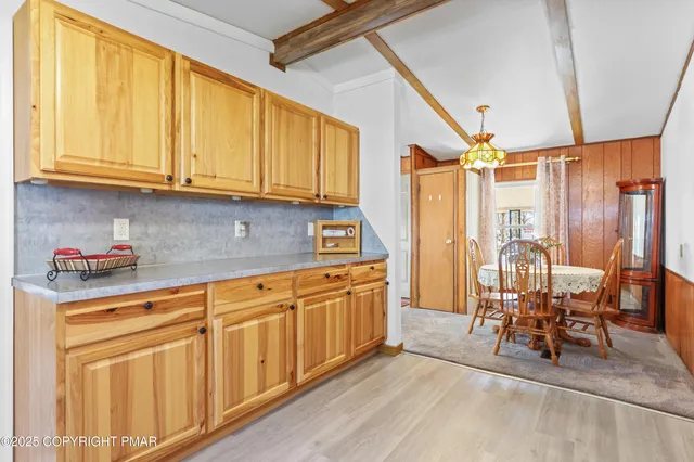a kitchen with stainless steel appliances granite countertop a refrigerator and cabinets