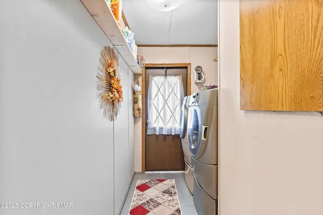 a view of walk in closet with clothes