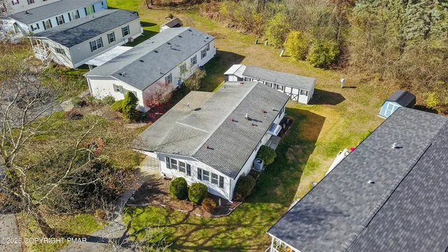 an aerial view of a house with a yard