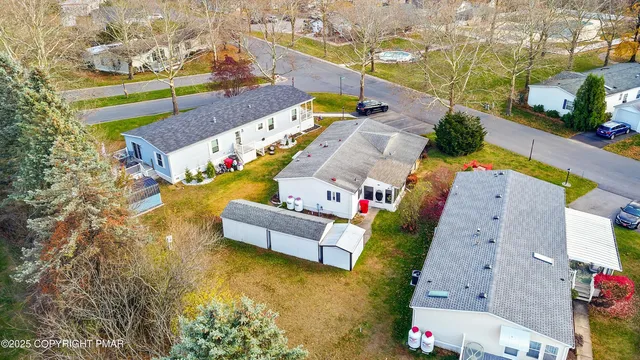 an aerial view of a house with a swimming pool