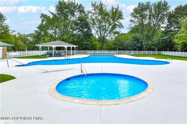 a view of a swimming pool with a yard