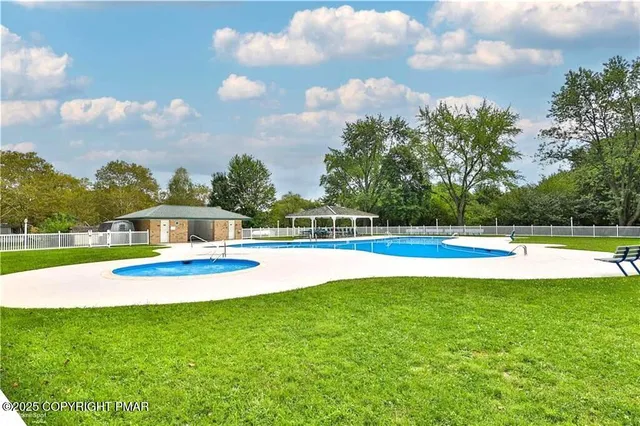 a view of a swimming pool with a yard