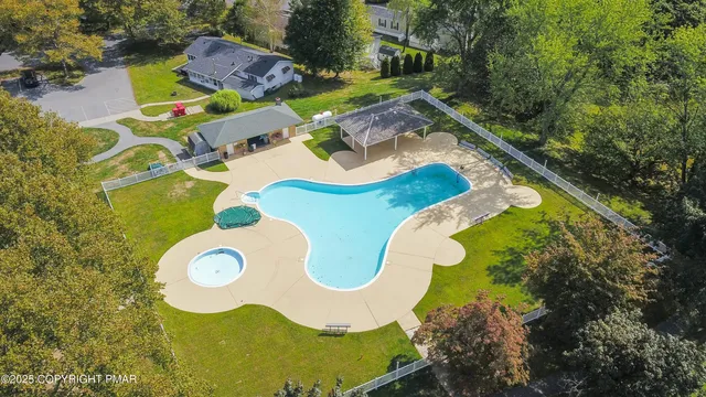a aerial view of a house with swimming pool and outdoor space