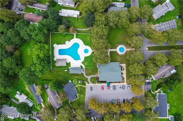 an aerial view of house with yard swimming pool and outdoor seating
