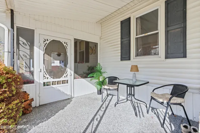 a view of a patio with table and chairs and potted plants