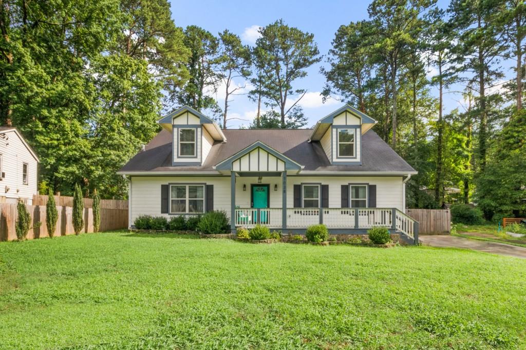 1038 Fairburn Road Northwest Atlanta, GA 30331 - Photo 1 of 1 a front view of a house with a yard and trees