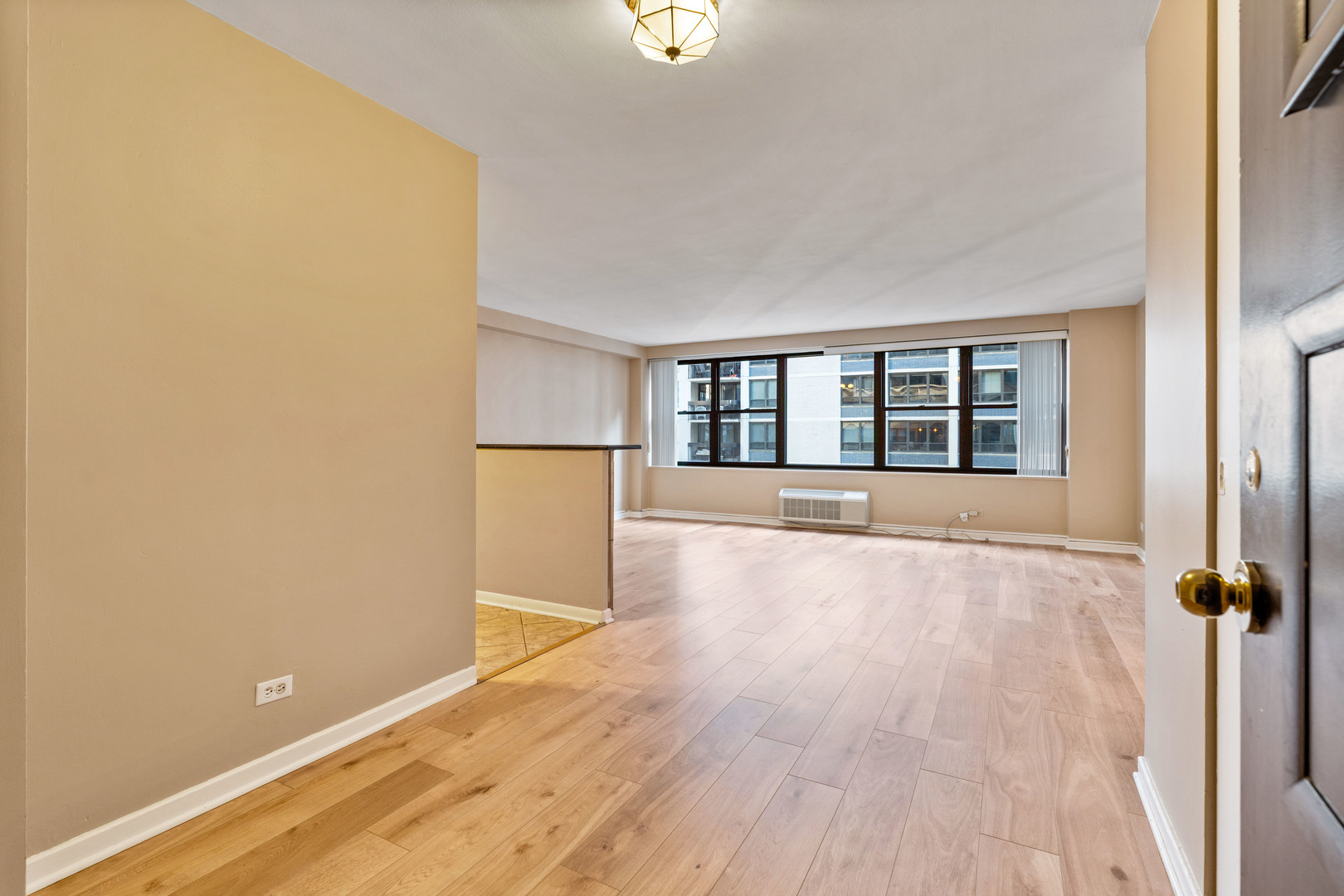 850 North Dewitt Place, Unit 11D Chicago, IL 60611 - Photo 2 of 15 wooden floor in an empty room with a window