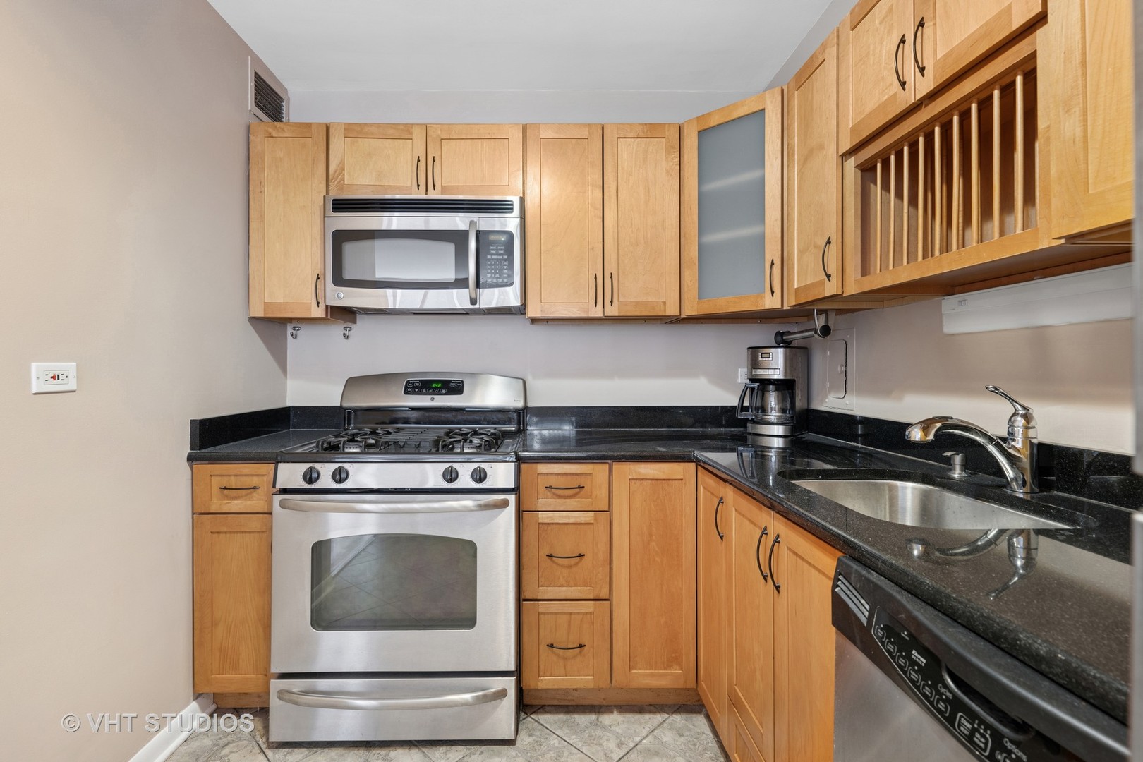 850 North Dewitt Place, Unit 11D Chicago, IL 60611 - Photo 5 of 15 a kitchen with stainless steel appliances granite countertop a sink stove and microwave