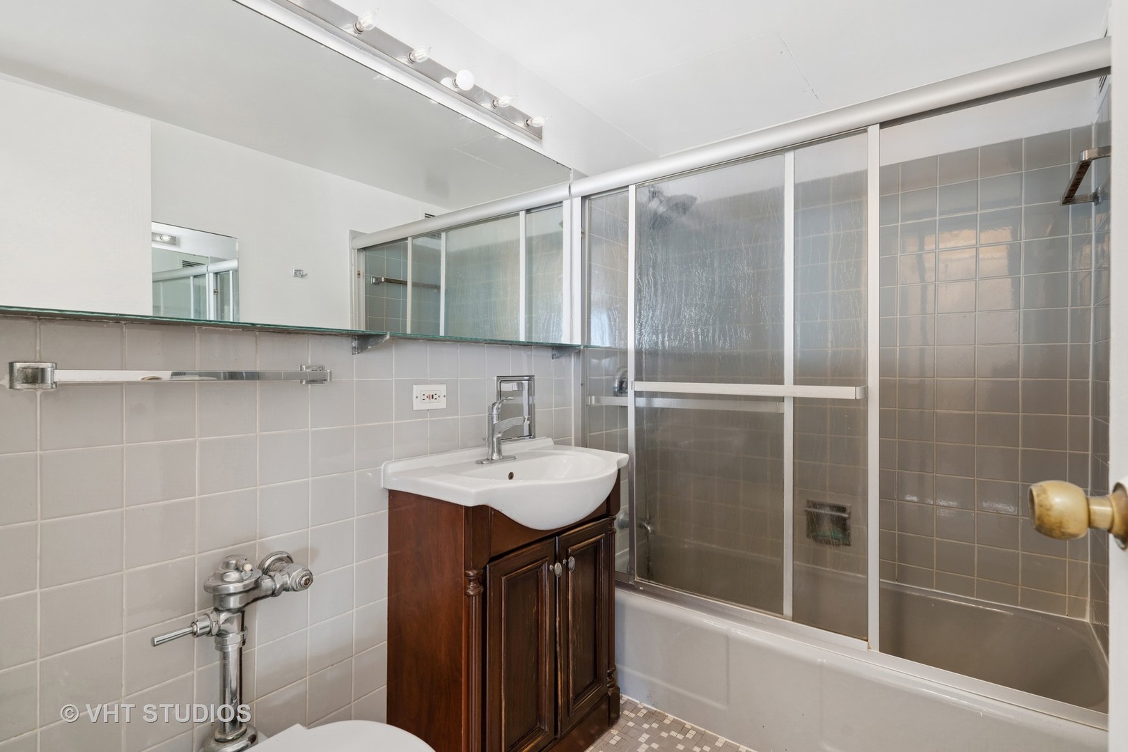850 North Dewitt Place, Unit 11D Chicago, IL 60611 - Photo 9 of 15 a bathroom with a sink shower and a mirror