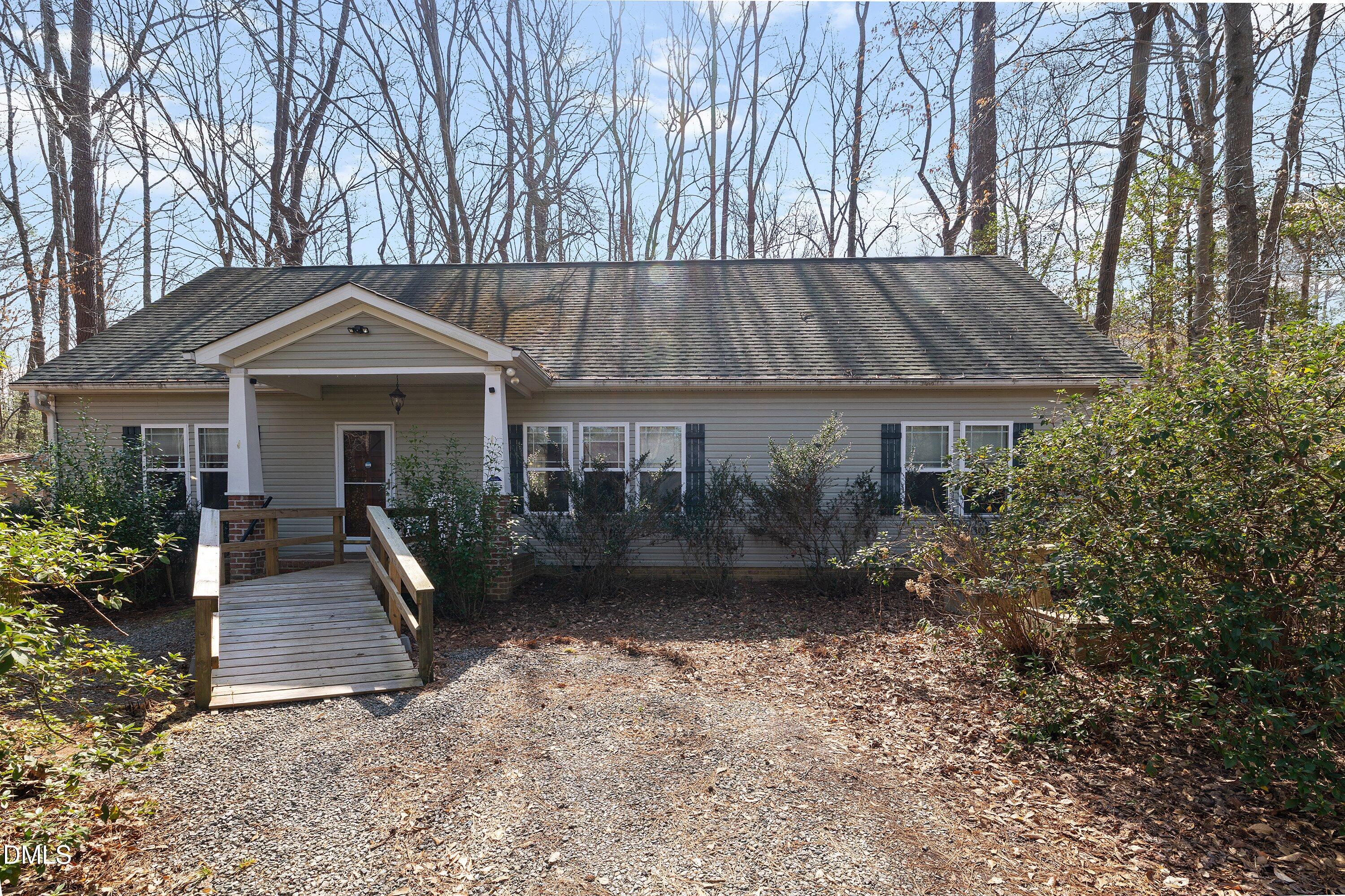 9713 Lake Wheeler Road Raleigh, NC 27603 - Photo 7 of 18 a front view of a house with garden