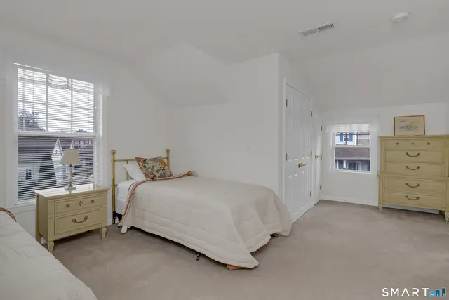 a room with a bed and a dresser