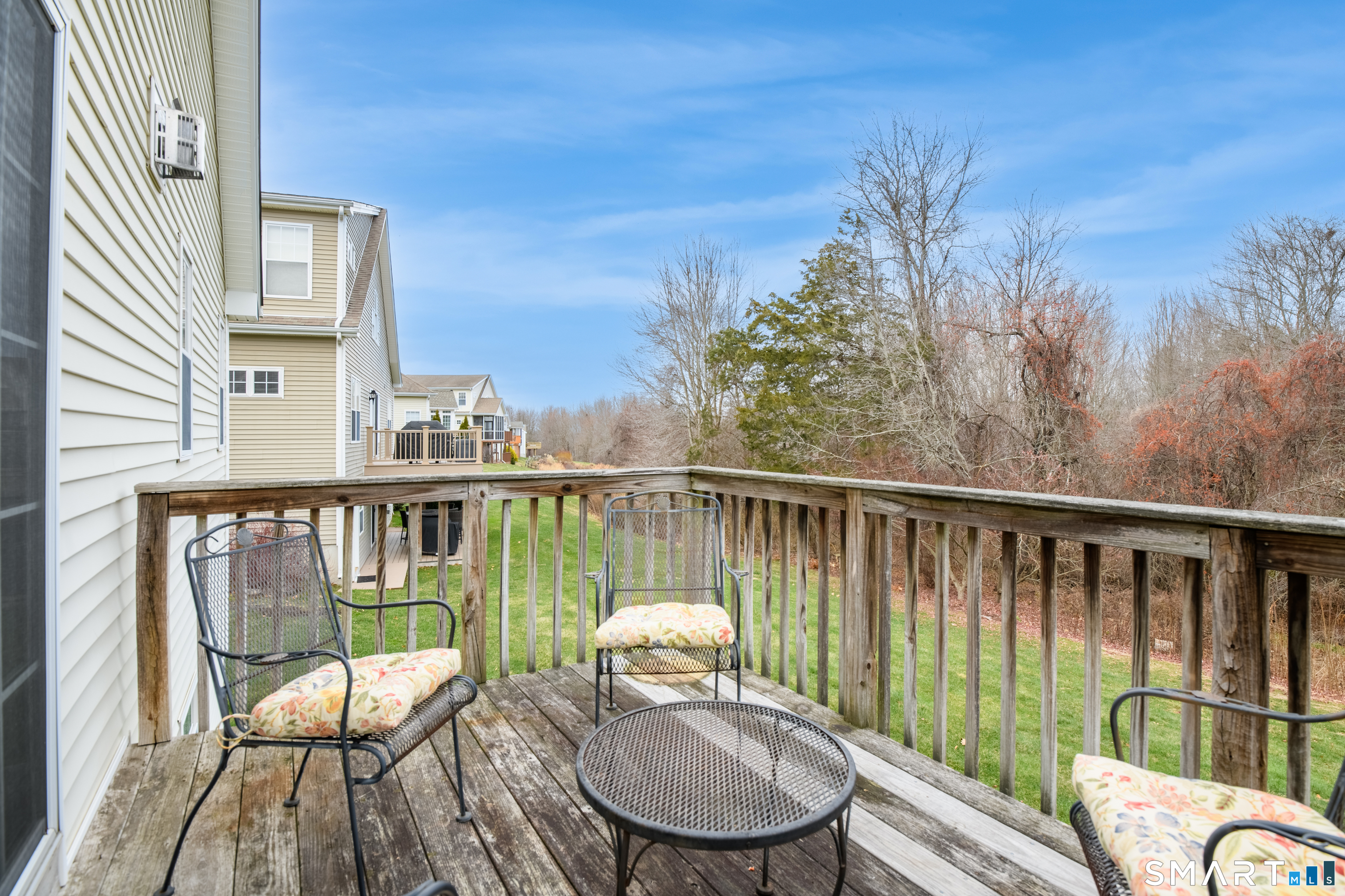 9 Pear Orchard Road, Unit 9 Portland, CT 06480 - Photo 31 of 38 a view of a deck with a chair and wooden floor