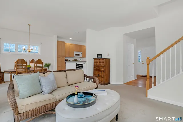 a living room with furniture and a dining table