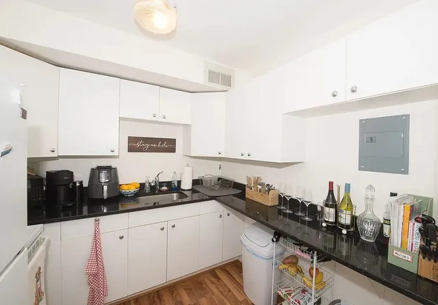 a kitchen with a refrigerator and a stove top oven