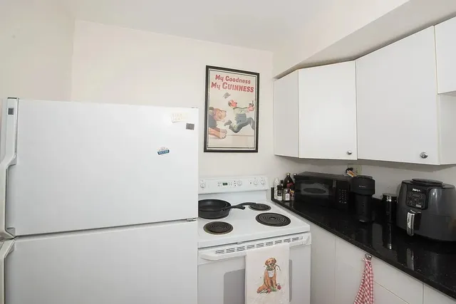 a bedroom with bed couch and window