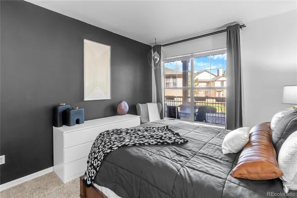 a bedroom with a bed and glass window