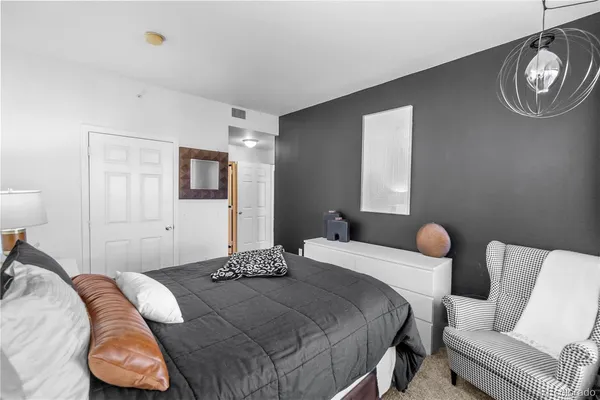 a bedroom with a bed and a chair