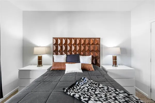 a bedroom with a bed and a lamp