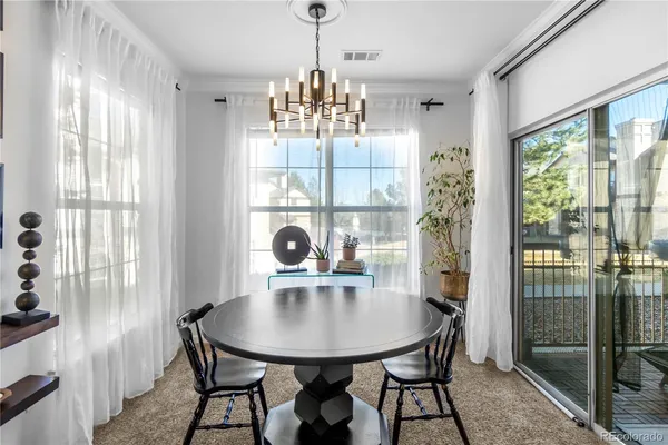 a view of a dining room with furniture window and outside view