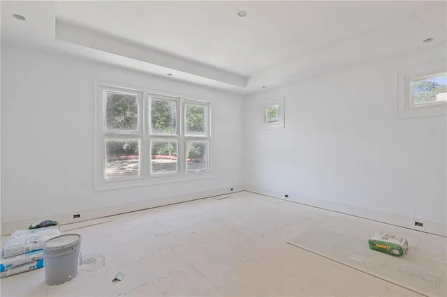 a view of wooden floor and window in a room