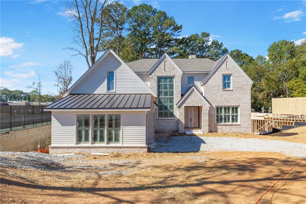 10908 Woodstock Road Roswell, GA 30075 - Photo 2 of 20 a front view of a house with a yard and garage