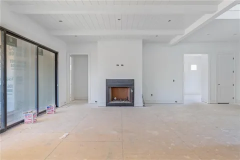 a view of an empty room with a fireplace
