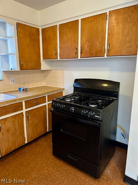 751 Thayer Street, Unit DOWN Akron, OH 44310 - Photo 9 of 25 Kitchen featuring sink, black range with gas cooktop, and tasteful backsplash