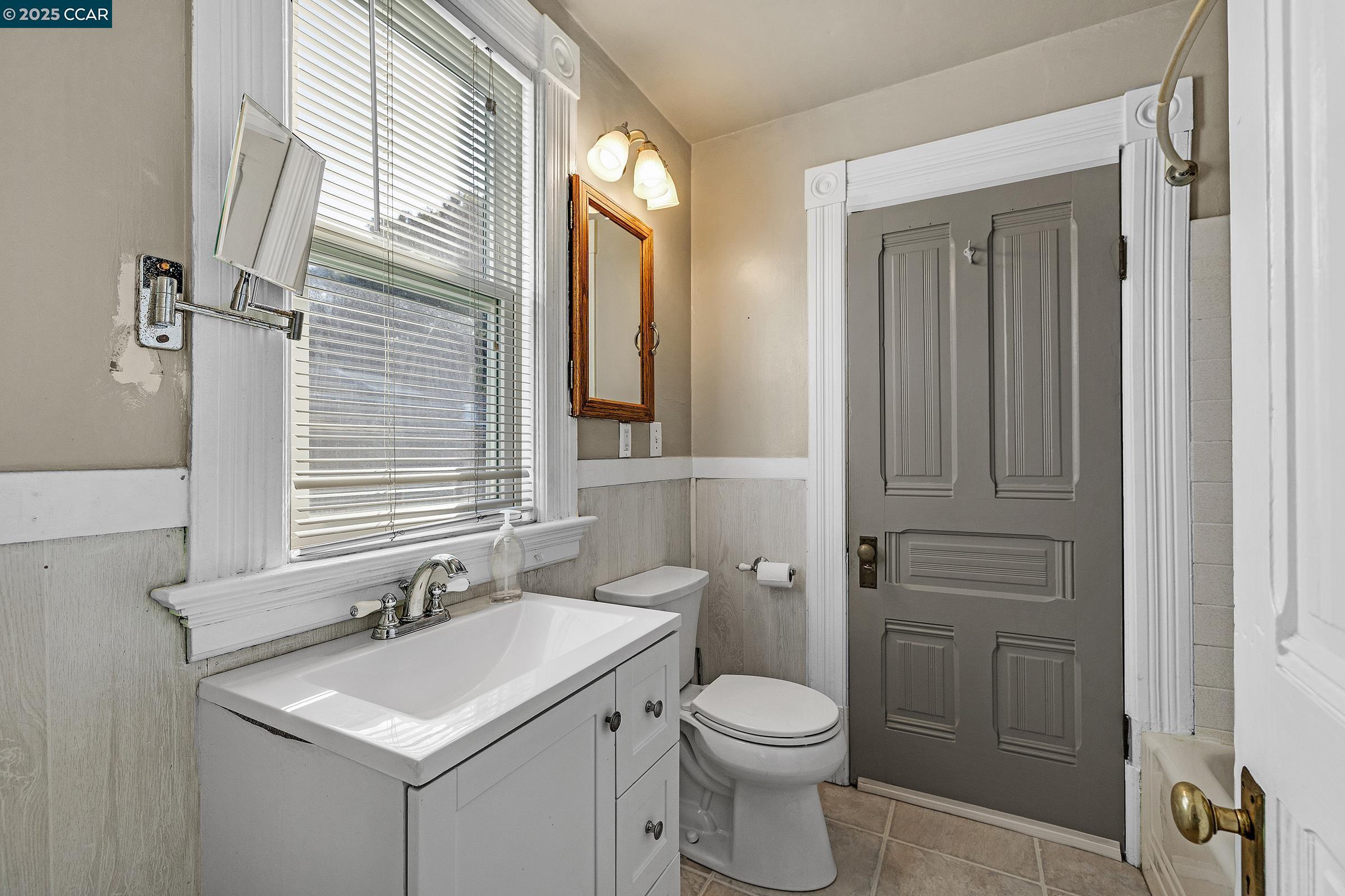 610 Quinan Street Pinole, CA 94564 - Photo 11 of 41 a bathroom with a sink a toilet and mirror