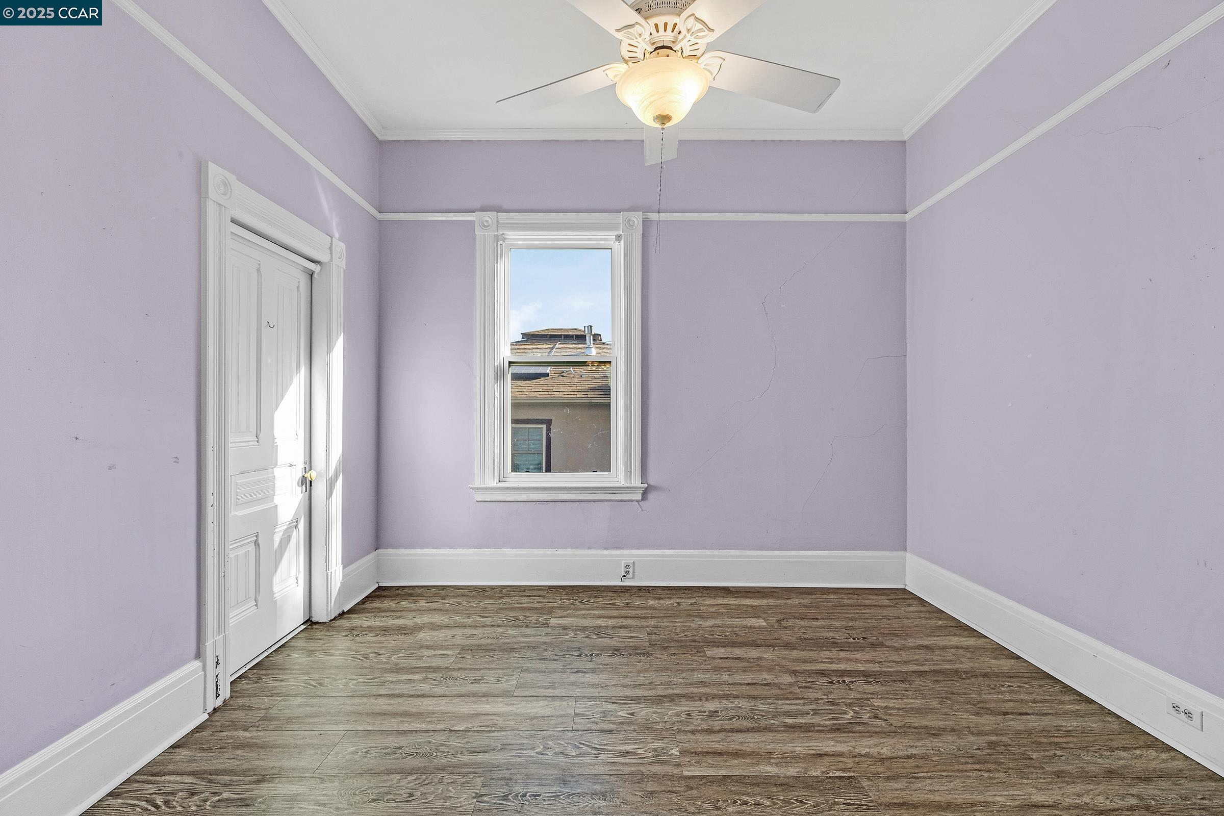 610 Quinan Street Pinole, CA 94564 - Photo 13 of 41 a view of an empty room with wooden floor and a window