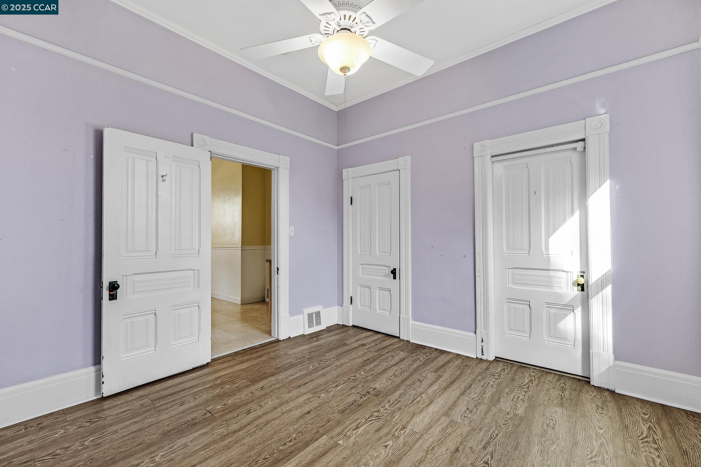 610 Quinan Street Pinole, CA 94564 - Photo 14 of 41 an empty room with wooden floor closet and windows