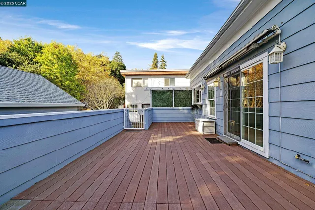 a view of backyard with wooden floor and fence