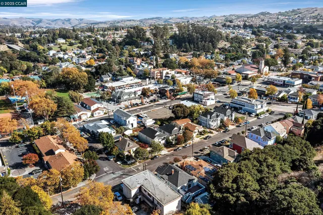 an aerial view of residential houses with city view