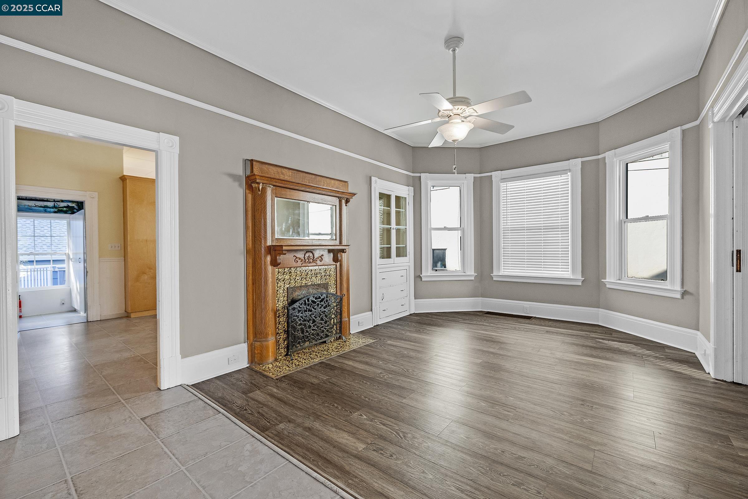 610 Quinan Street Pinole, CA 94564 - Photo 8 of 41 an empty room with wooden floor chandelier and windows
