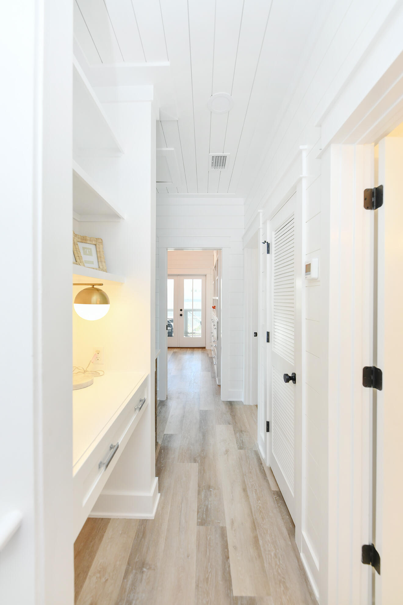 20 Brown Street Santa Rosa Beach, FL 32459 - Photo 59 of 83 a view of a hallway with wooden floor and a bathroom