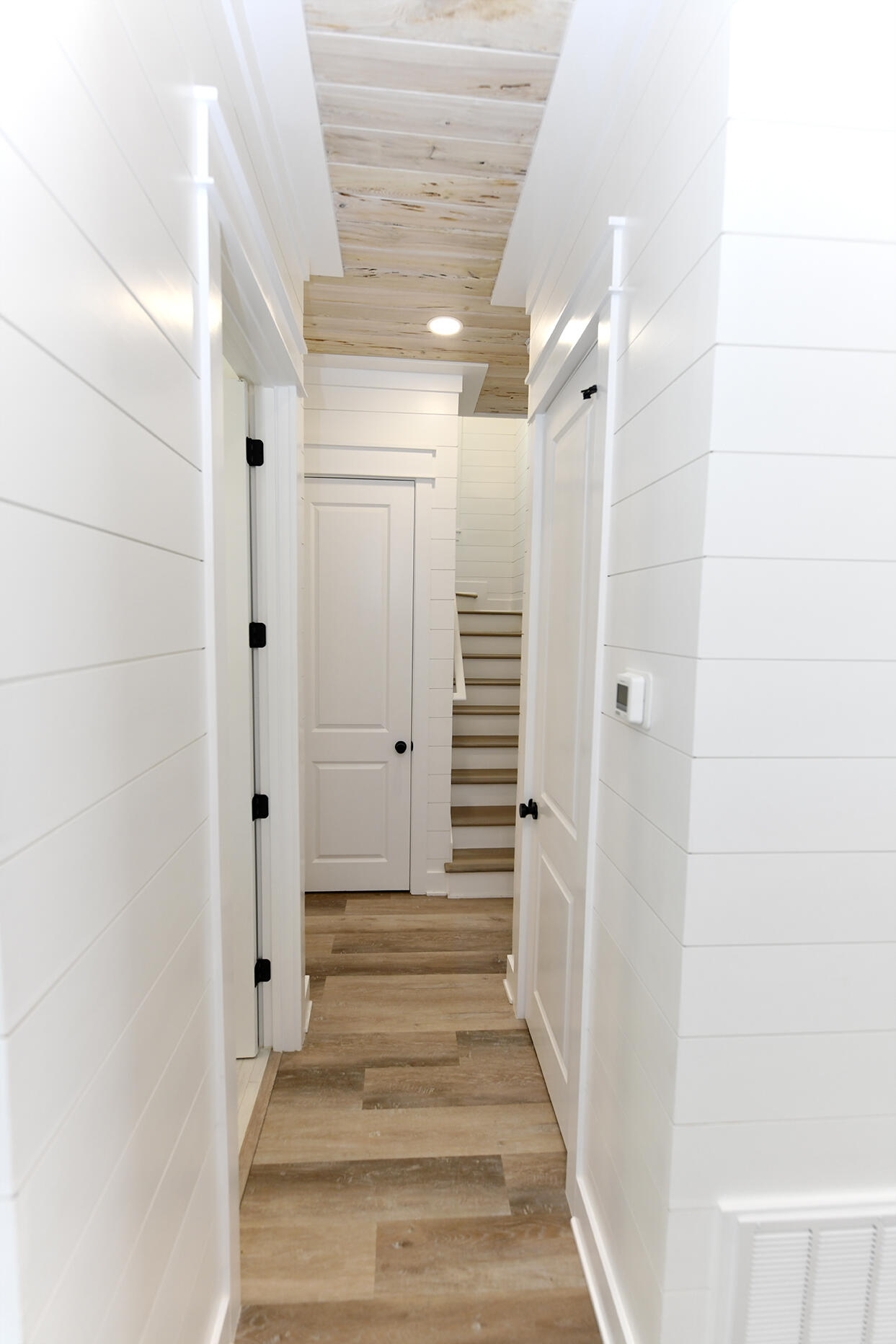 20 Brown Street Santa Rosa Beach, FL 32459 - Photo 65 of 83 a view of a hallway with wooden floor and staircase