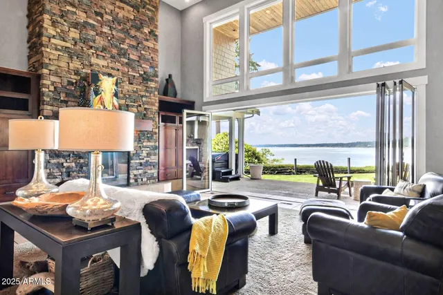 a view of a living room with furniture and floor to ceiling windows