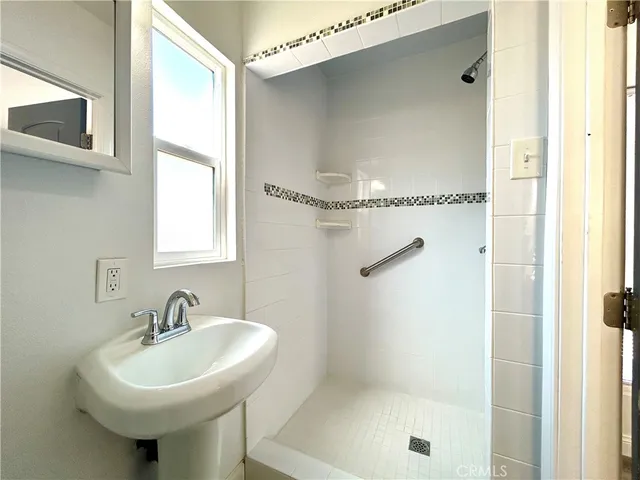 a bathroom with a sink toilet and a mirror