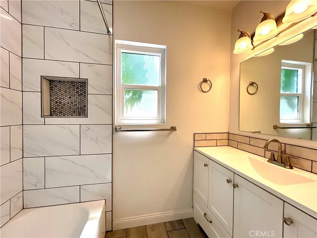 a bathroom with a sink a vanity and window