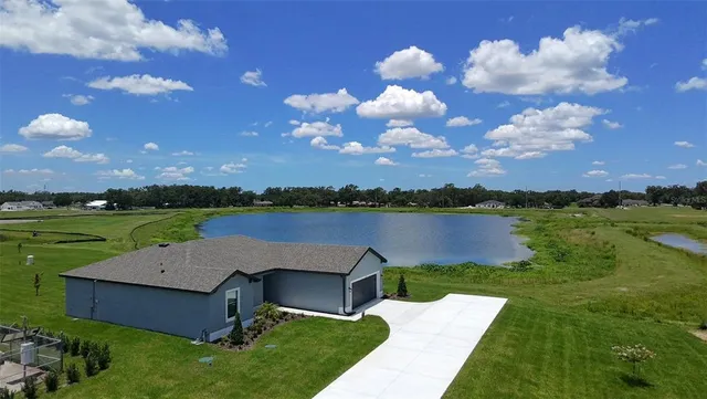 a view of a lake with couches and city view