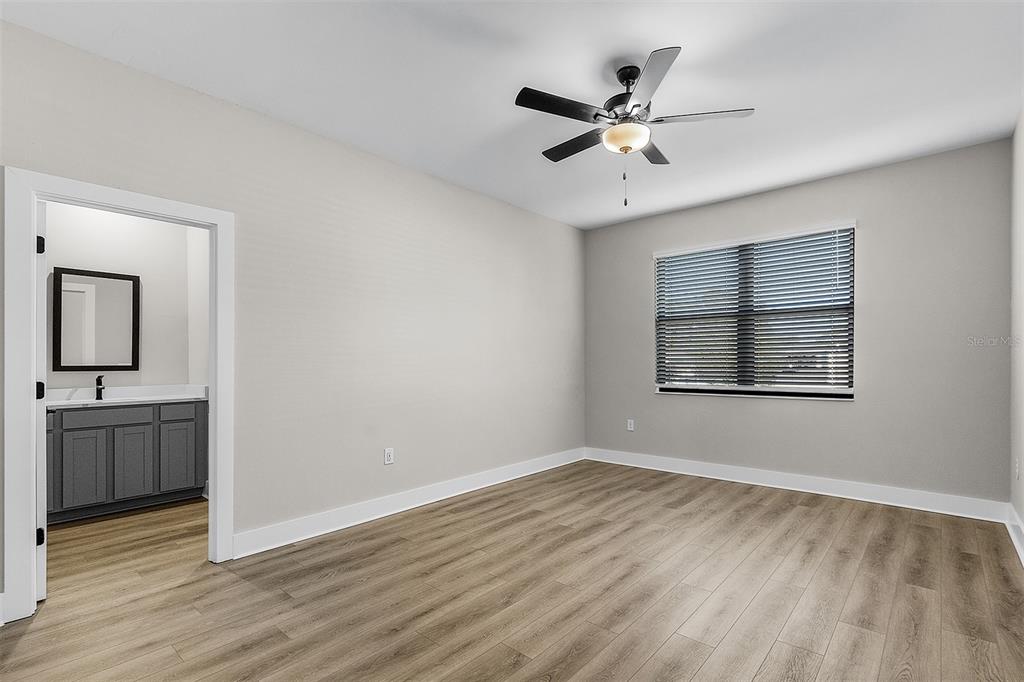 2426 Hiers Road Dover, FL 33527 - Photo 7 of 8 wooden floor in an empty room with a window