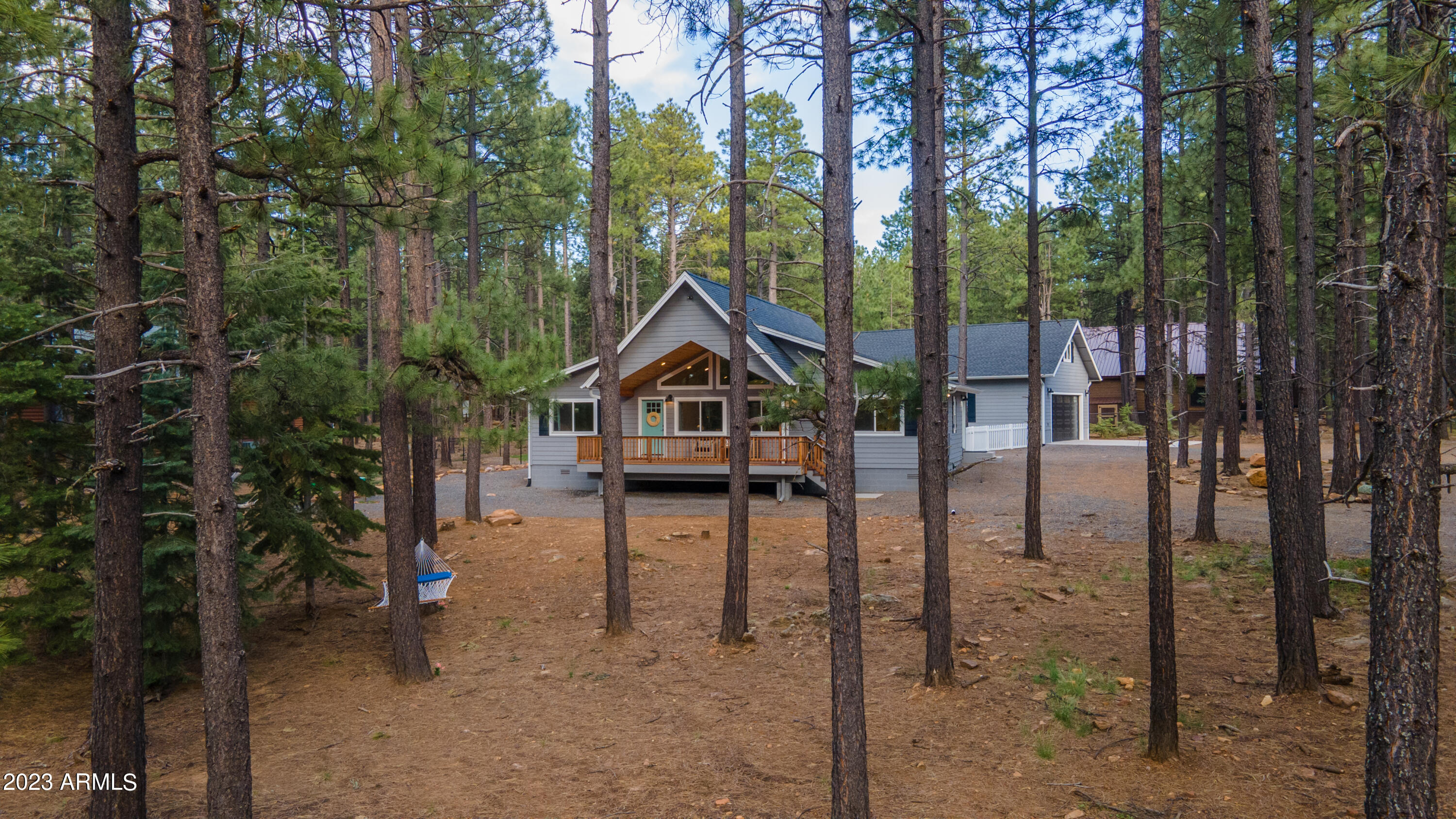 a house view with a trees in the background