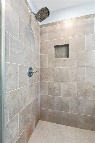 a view of walk in closet and bedroom