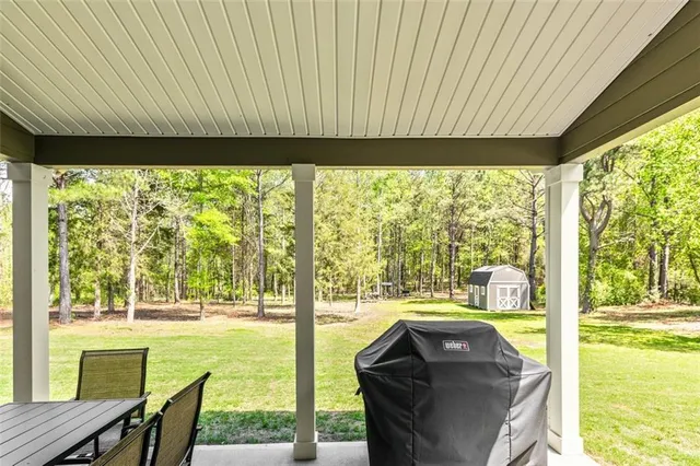 a front view of a house with a yard and trees